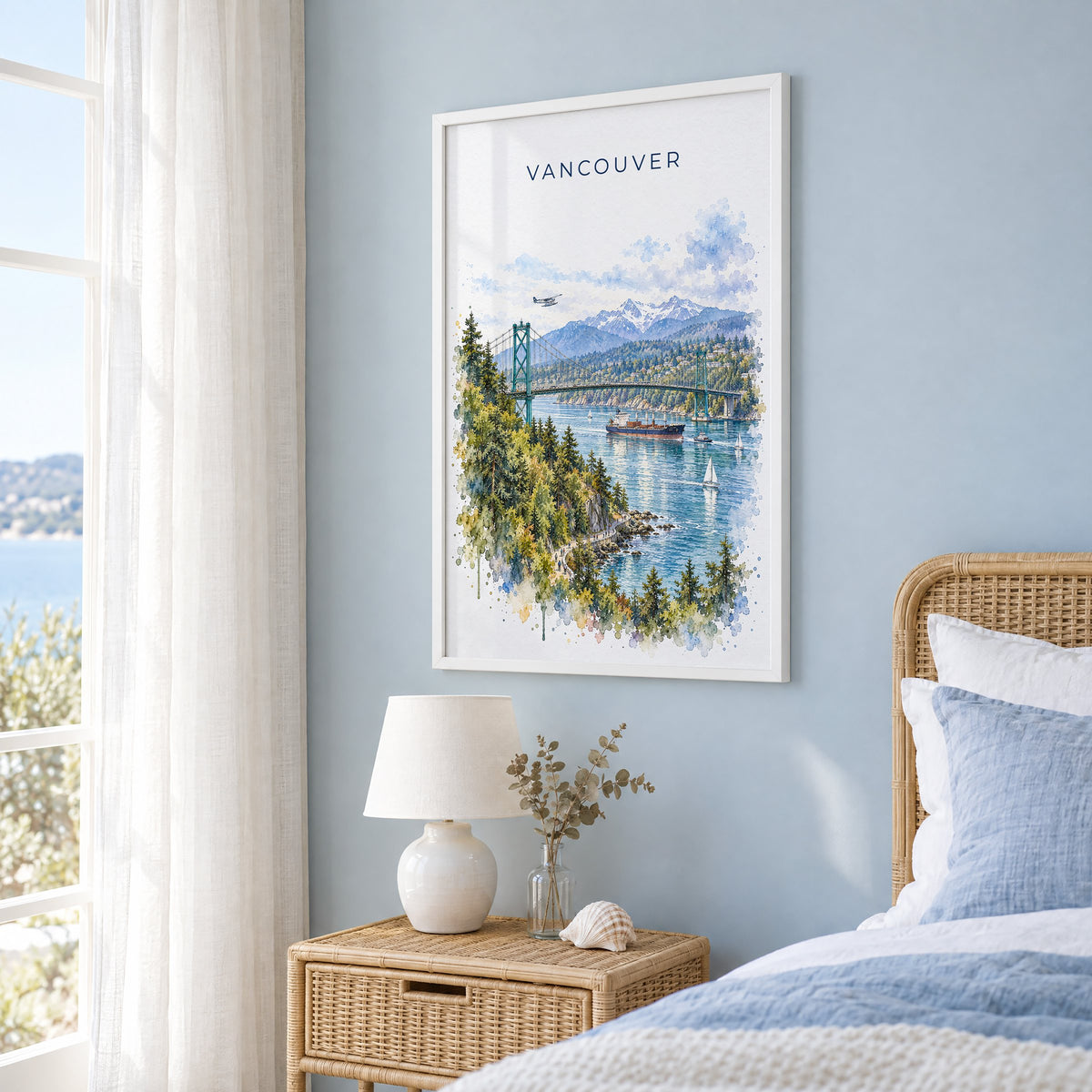 Vancouver watercolor print in a white frame on a pale blue wall beside a rattan bed in a coastal bedroom