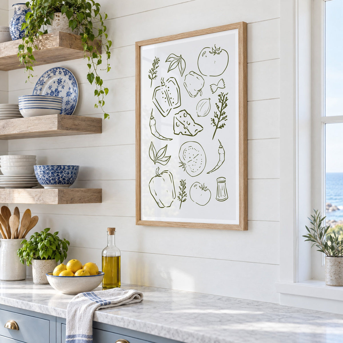 Olive line veggies and farfalle pattern in an oak frame in a white coastal kitchen beside blue and white plates
