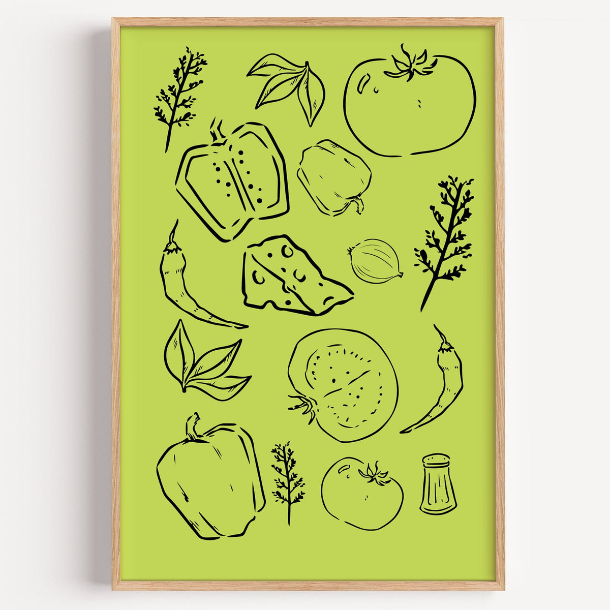Veggie and cheese line art on green print in a light oak frame on a plain white wall