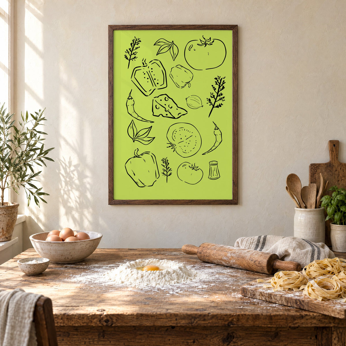 Veggie and cheese line art on green print in a walnut frame above a rustic table set for making fresh pasta