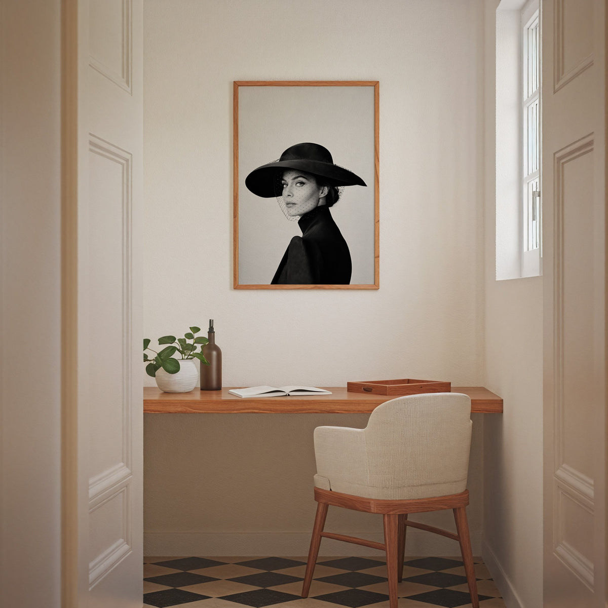 Woman in wide brim hat and mesh veil print in an oak frame above a home office desk nook