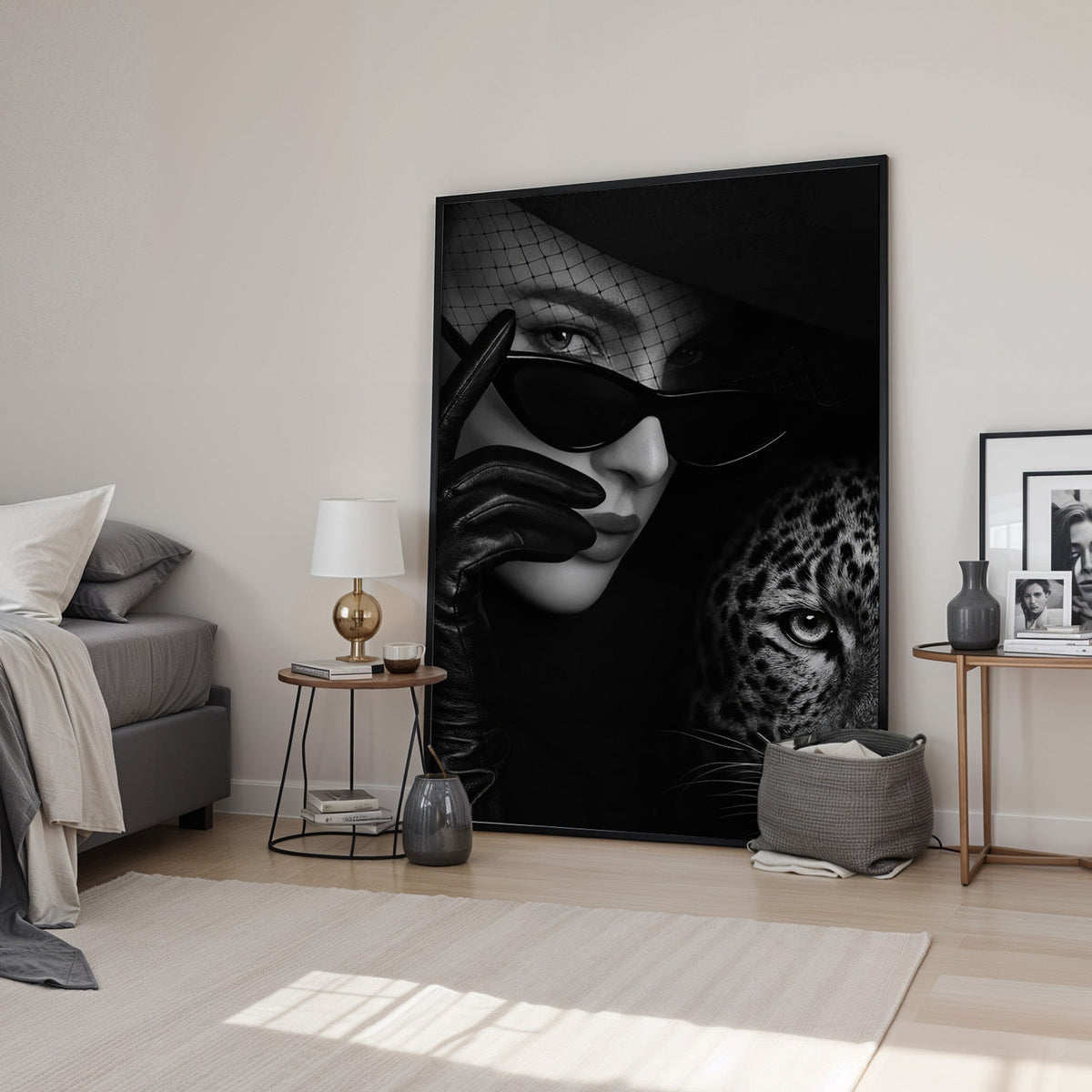 Veiled woman in cat eye glasses with leopard print in a black frame leaning in a bedroom beside a gold lamp