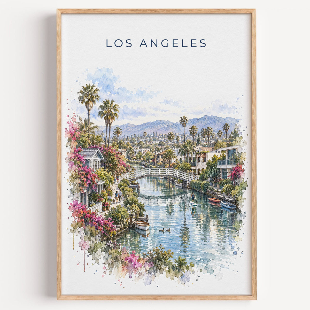Venice Canals Los Angeles watercolor print in a light oak frame on a plain white wall