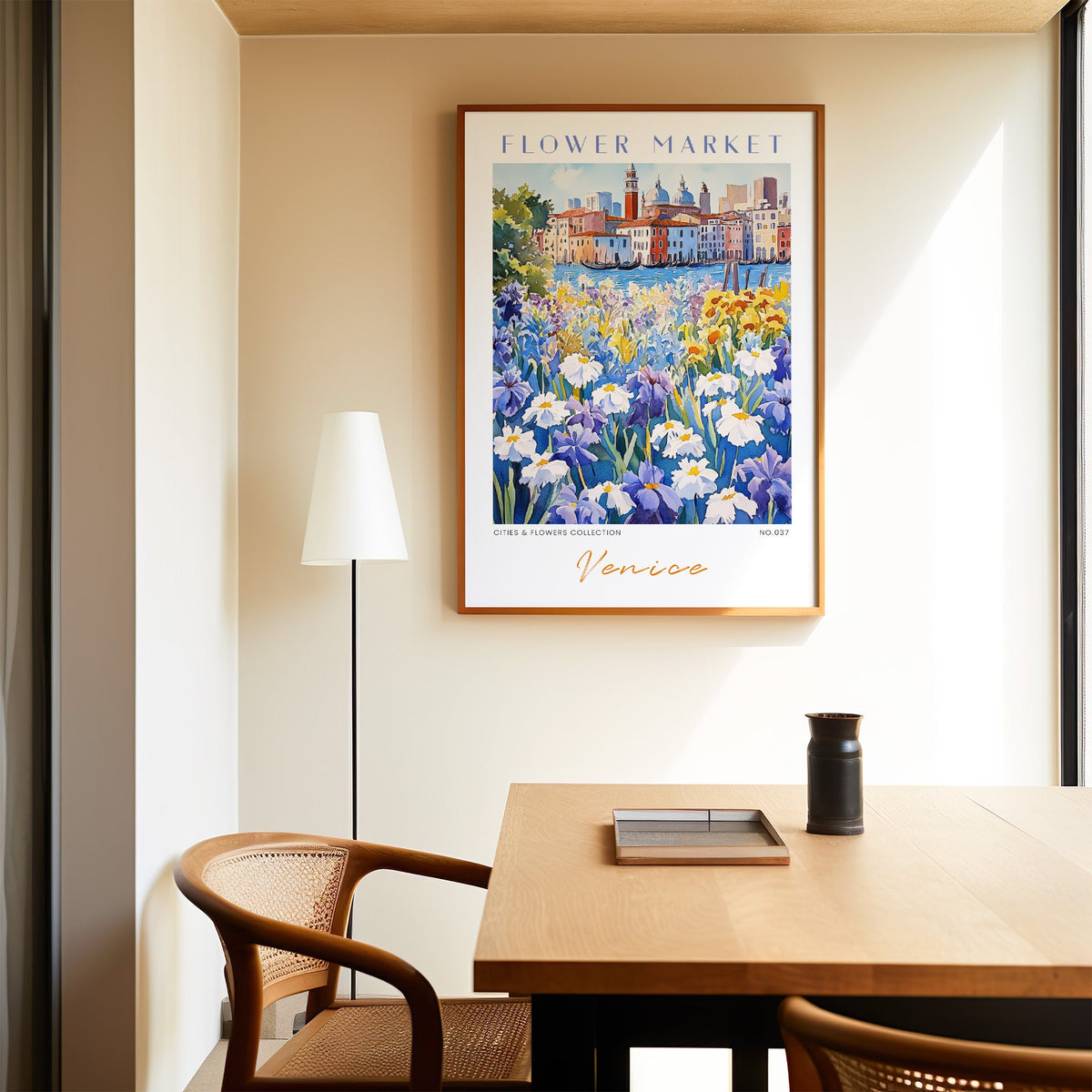 Venice flower market print in an oak frame above a dining table and cane chair