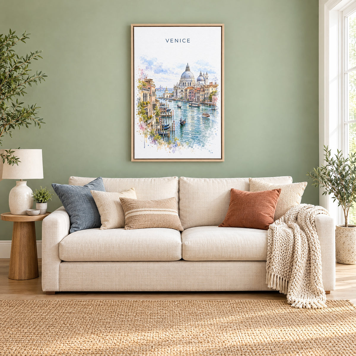 Venice watercolor print as a natural floater canvas above a cream linen sofa on a sage green wall
