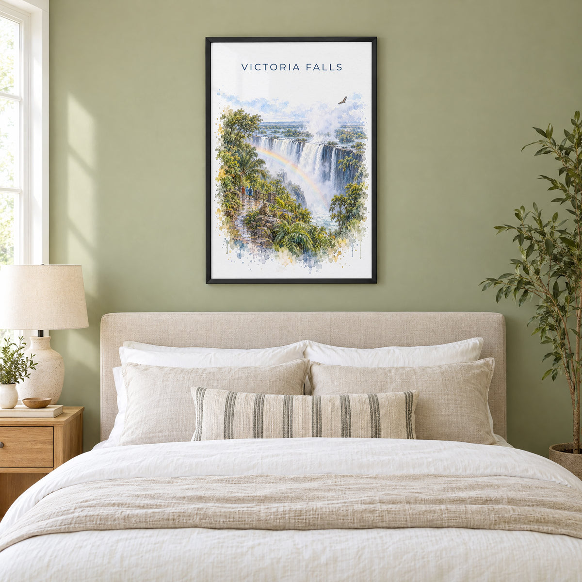 Victoria Falls watercolor print in a black frame above an upholstered headboard in a sage green bedroom