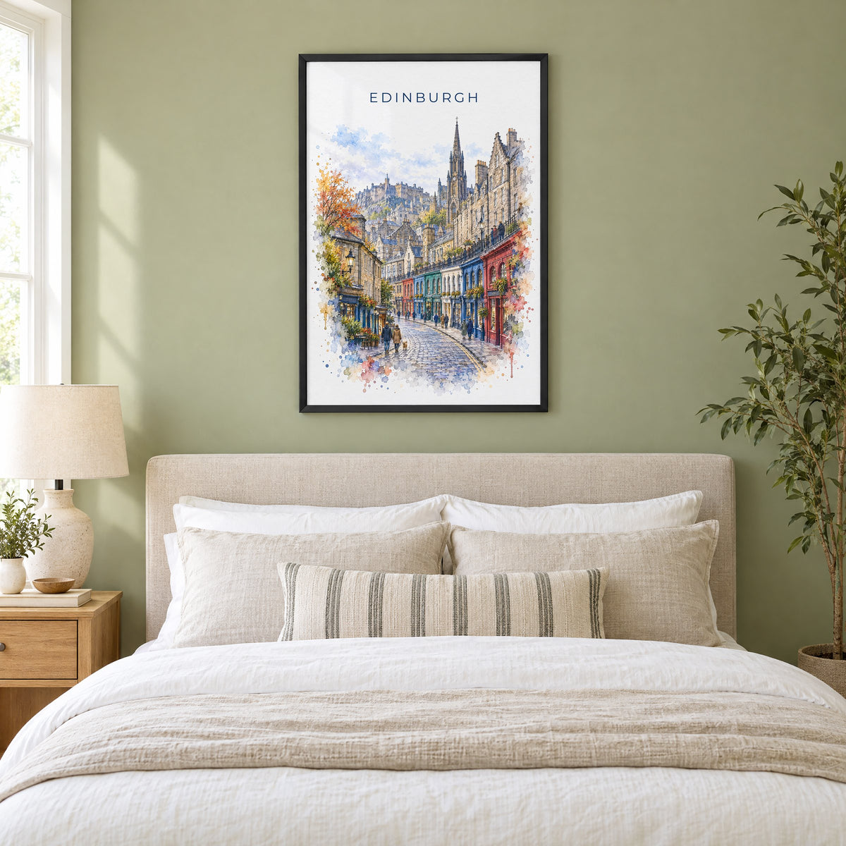 Victoria Street Edinburgh watercolor print in a black frame above an upholstered headboard in a sage green bedroom