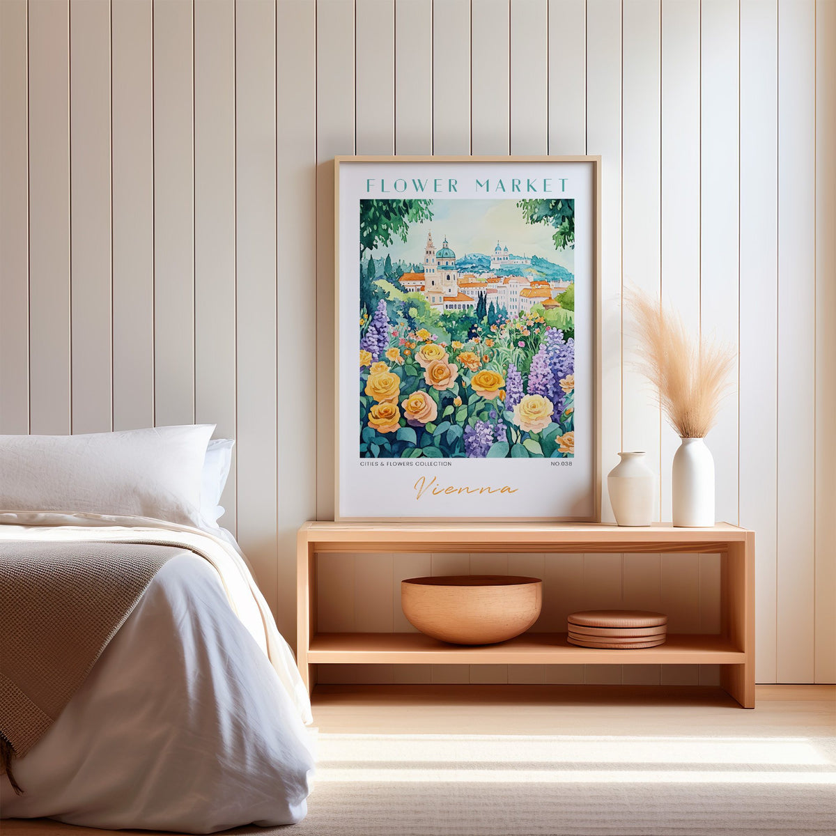 Vienna flower market print in an oak frame on a wood bench against a white shiplap bedroom wall with pampas grass