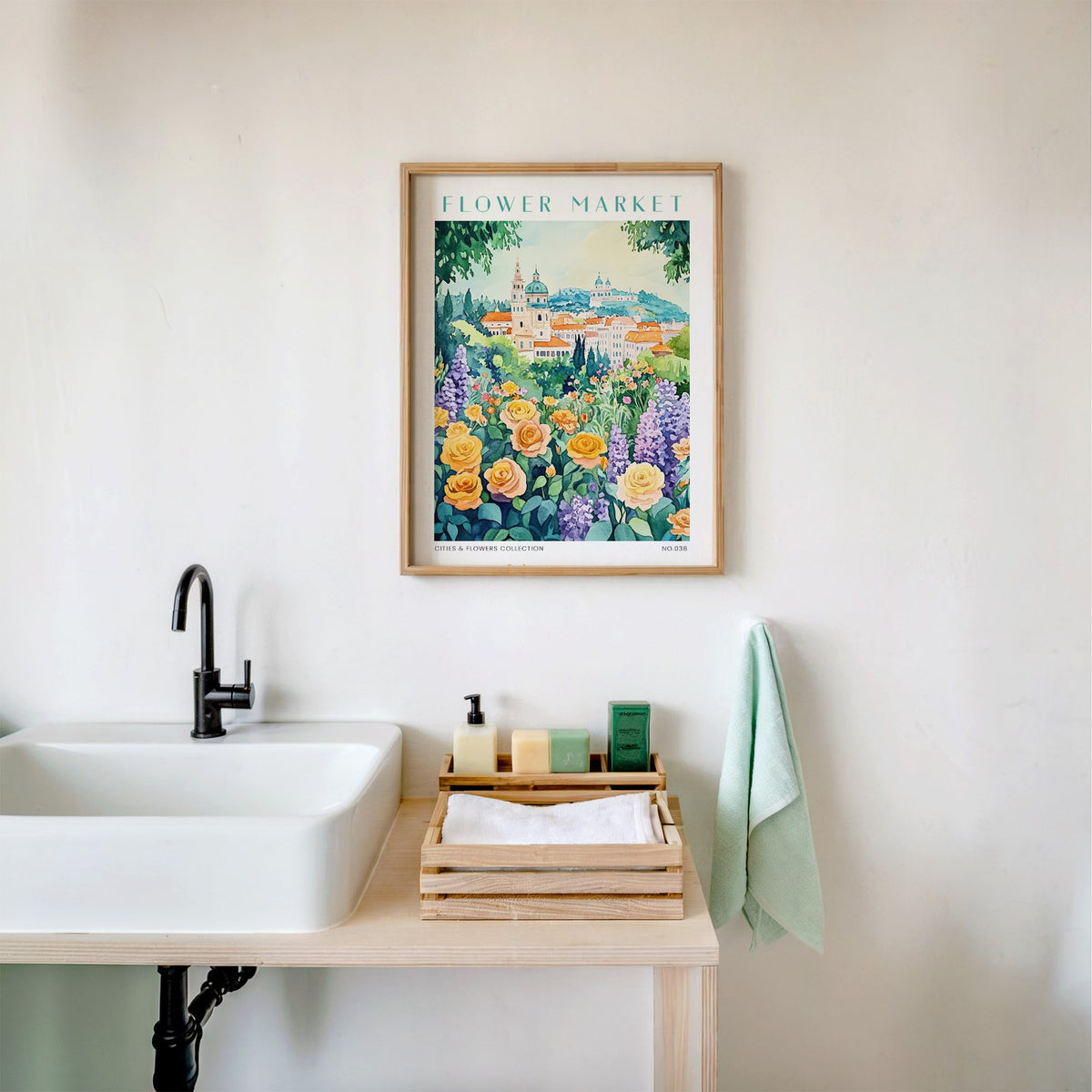 Vienna flower market print in an oak frame above a white bathroom sink with folded towels