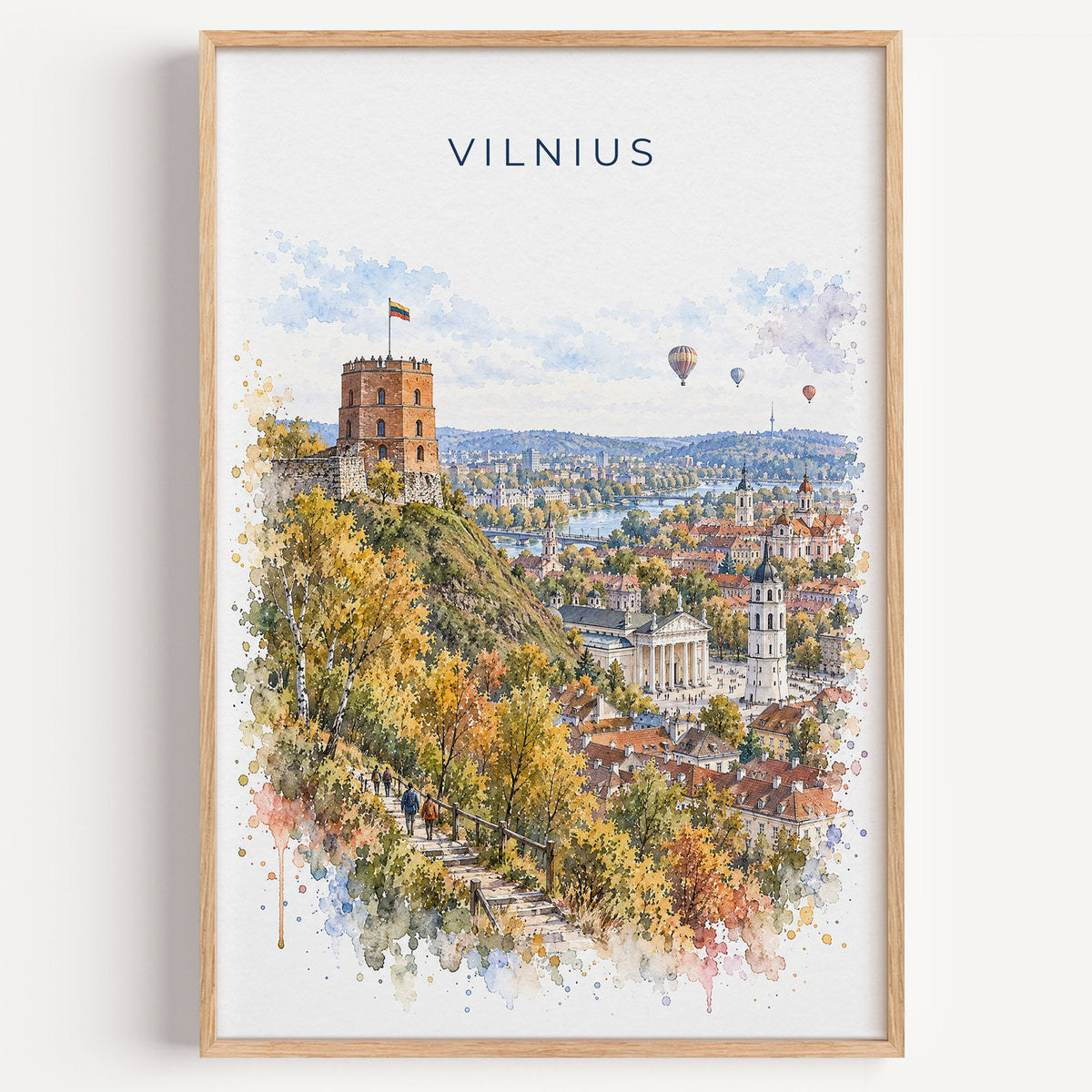 Vilnius watercolor print in a light oak frame on a plain white wall