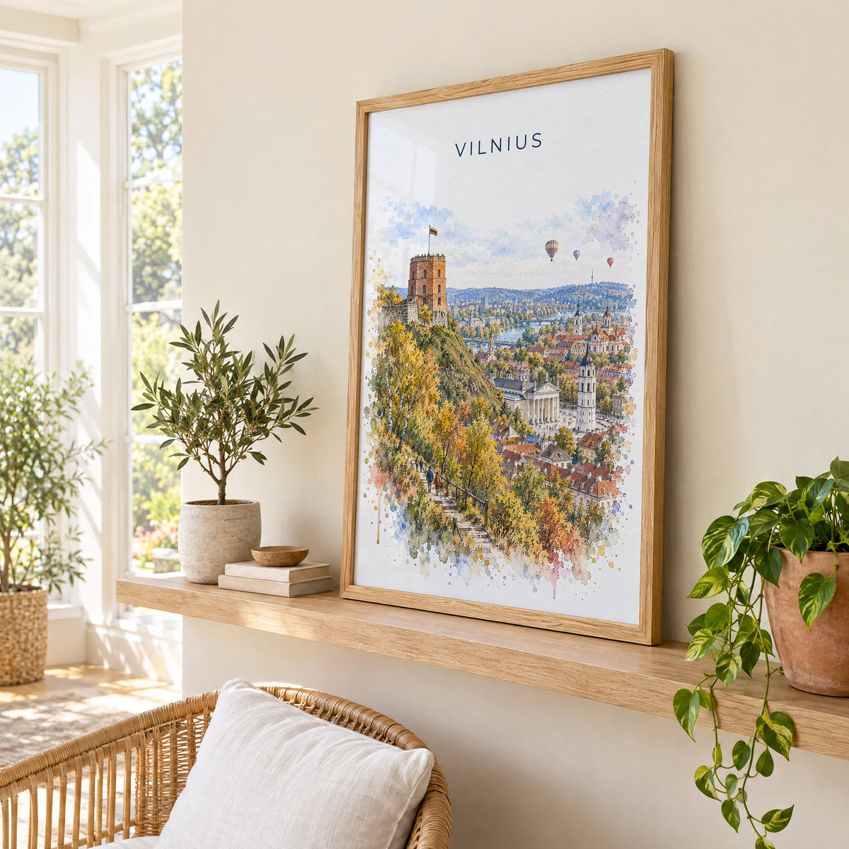 Vilnius watercolor print in an oak frame on a picture ledge in a sunlit sunroom
