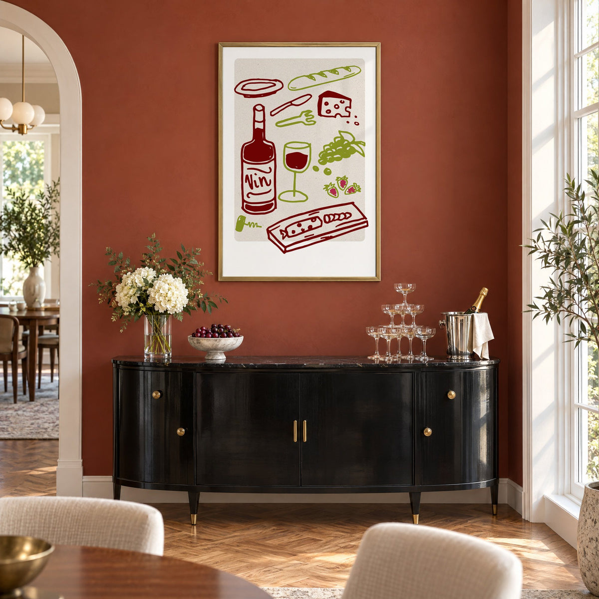 Vin wine picnic doodle print in a brass frame on a terracotta wall above a black buffet with a champagne tower