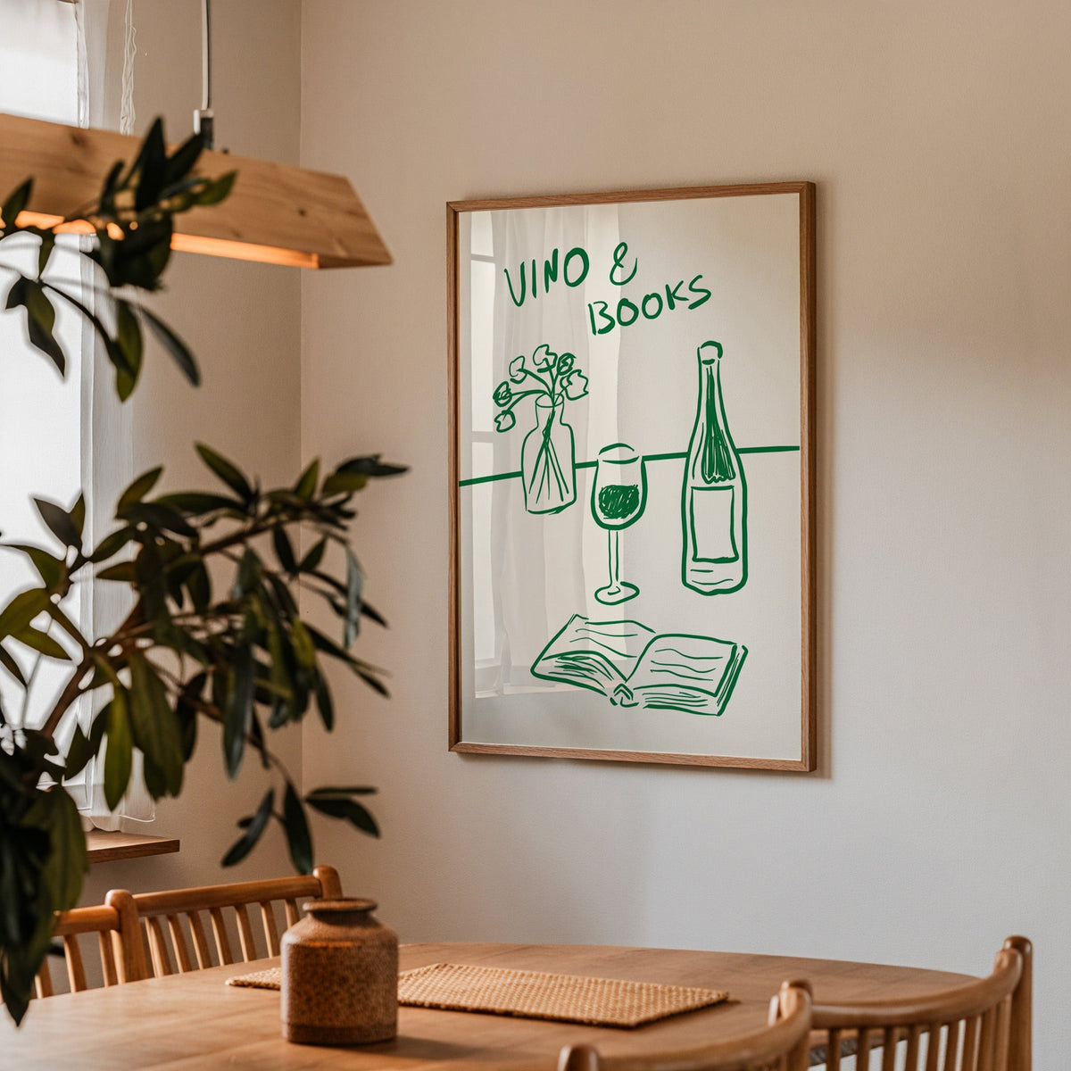 Vino and books green line print in a walnut frame above a table by an olive tree