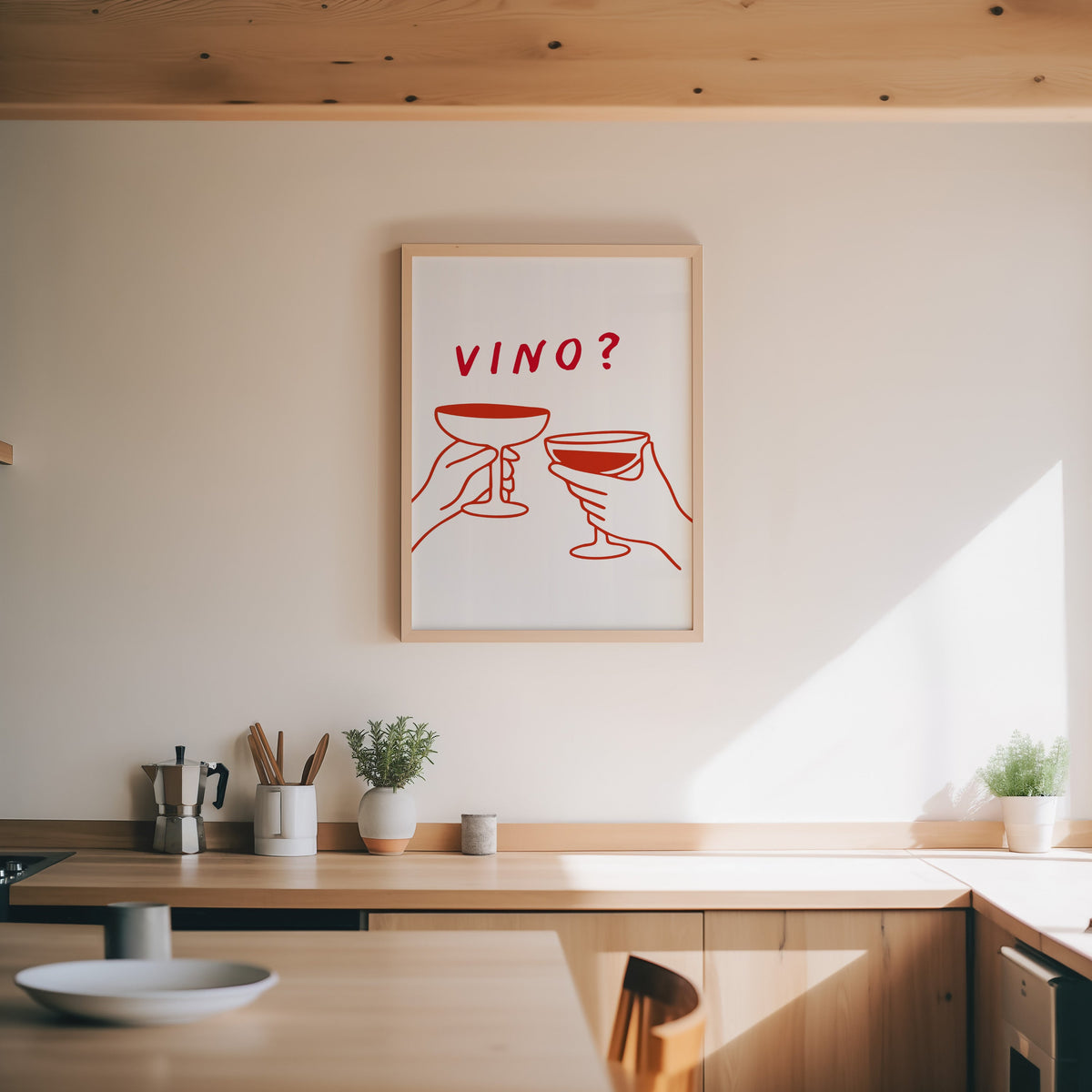 Vino print in an oak frame above a wood counter with a moka pot and herbs