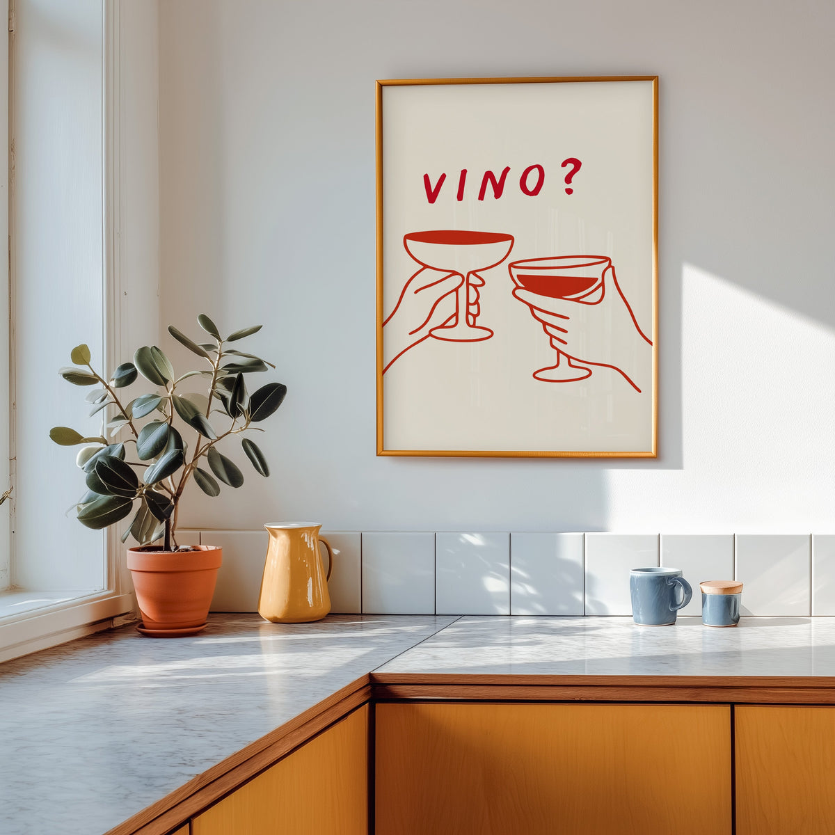 Vino print shown in a gold frame above a marble counter with a yellow ceramic jug