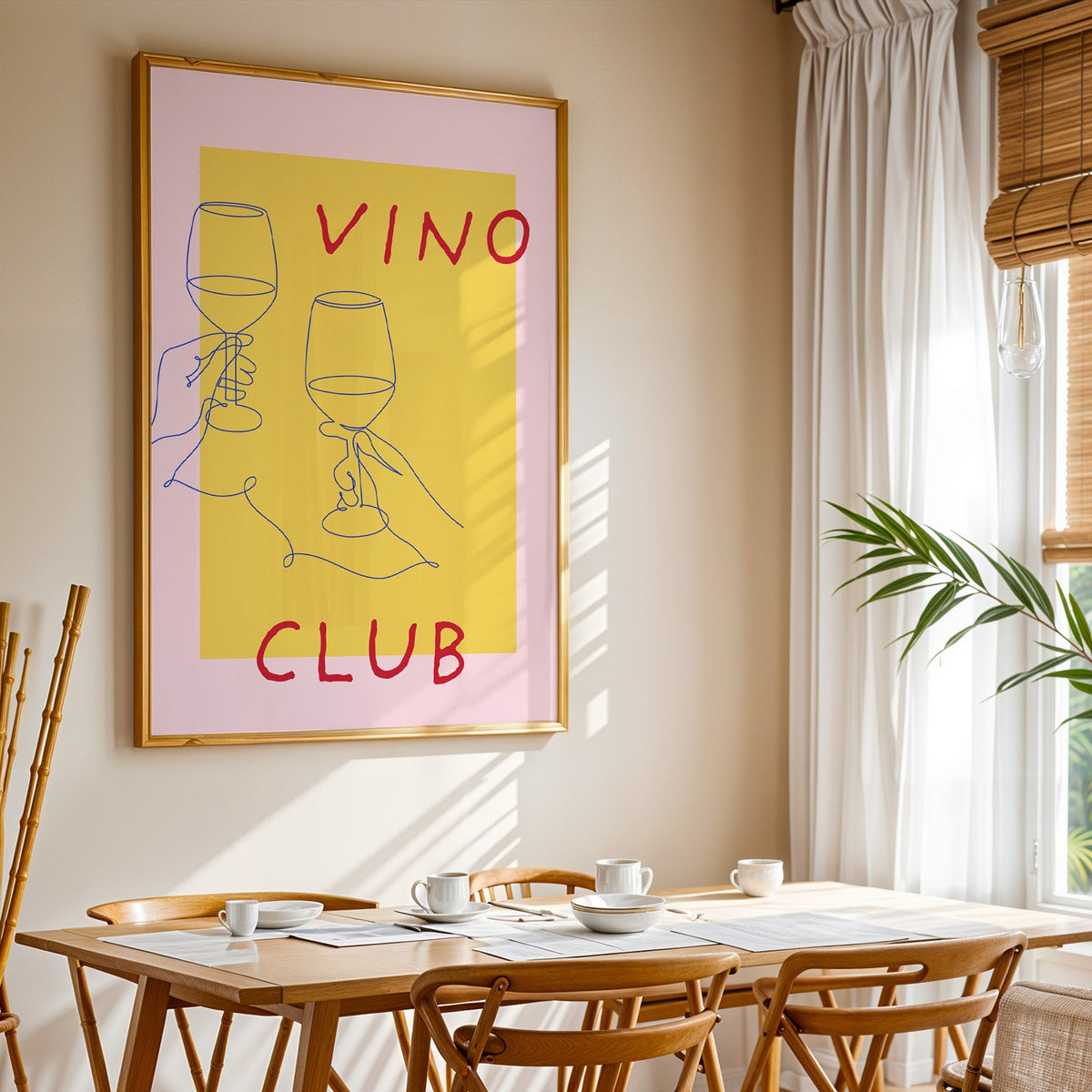 Vino Club print shown in a gold frame above a breakfast table by a curtained window