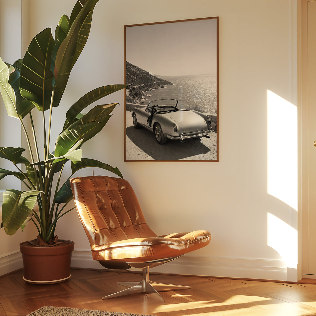 Vintage convertible parked above the sea print in a walnut frame above a leather lounge chair