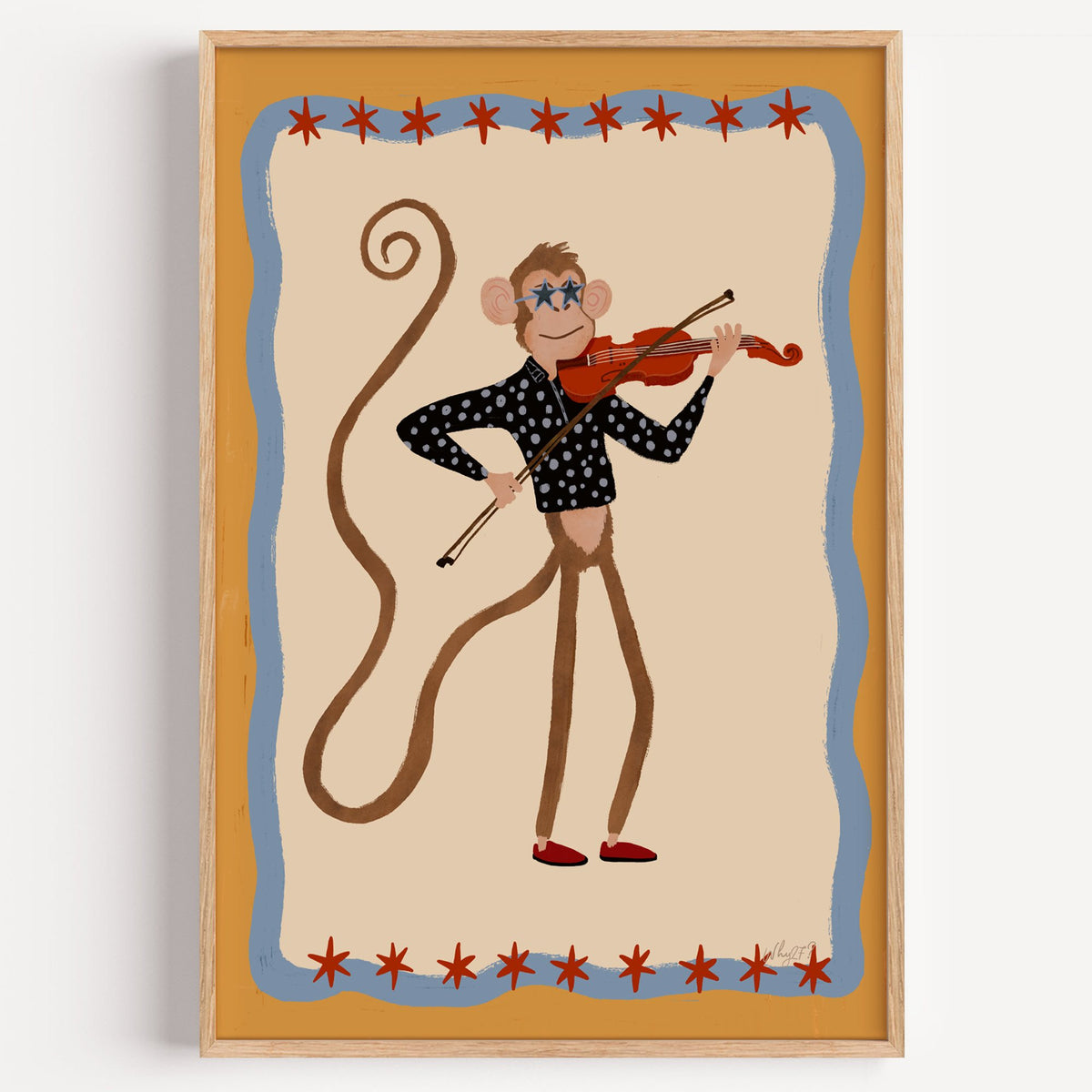 Monkey playing red violin nursery print in a light oak frame on a plain white wall
