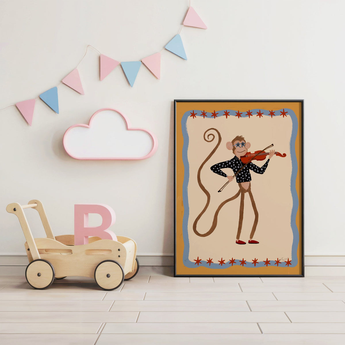 Monkey playing red violin nursery print in a black frame under pastel bunting by a wooden baby walker