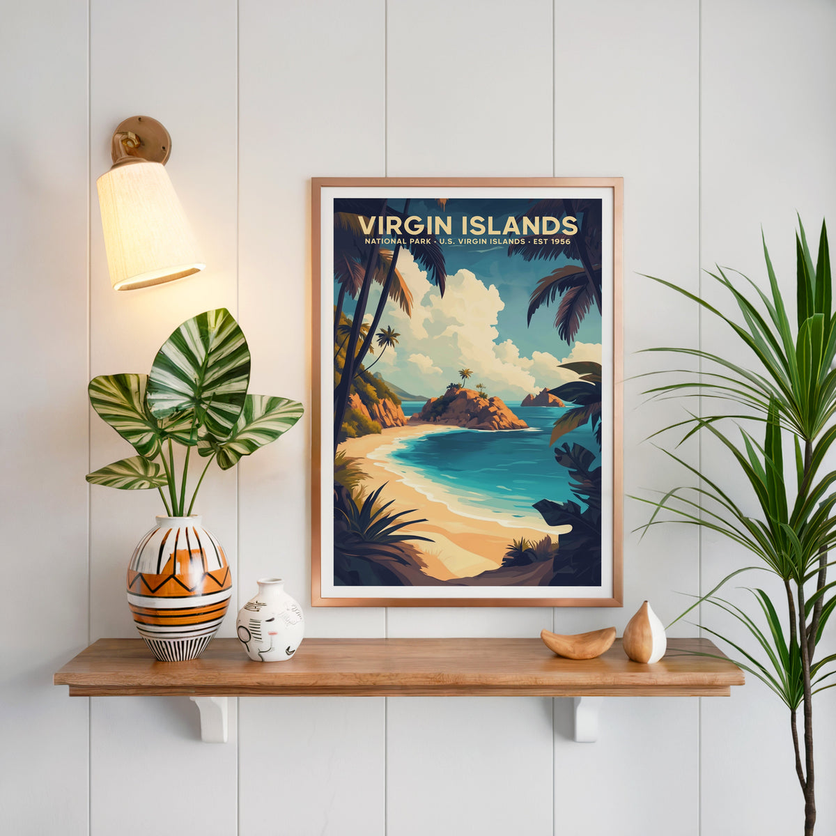 Virgin Islands National Park print in a copper frame above an oak shelf on shiplap with a brass sconce