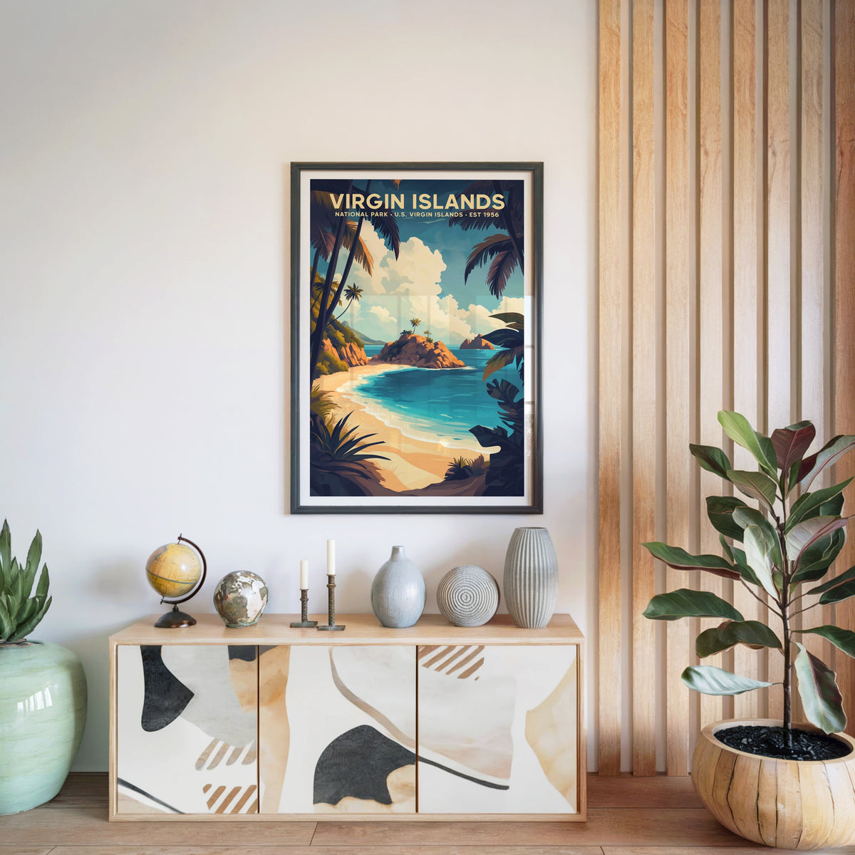 Virgin Islands National Park print in a black frame above a light wood sideboard with a globe and vases