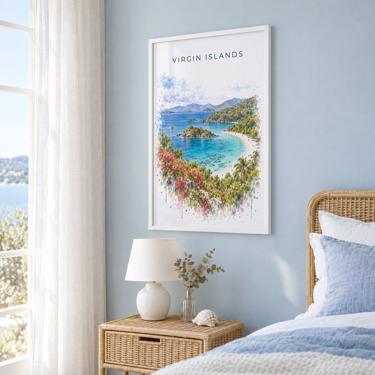 Virgin Islands National Park watercolor print in a white frame on a pale blue wall beside a rattan bed in a coastal bedroom