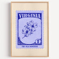 Virginia state flower stamp print in blue violet on periwinkle, light oak frame on a plain white wall