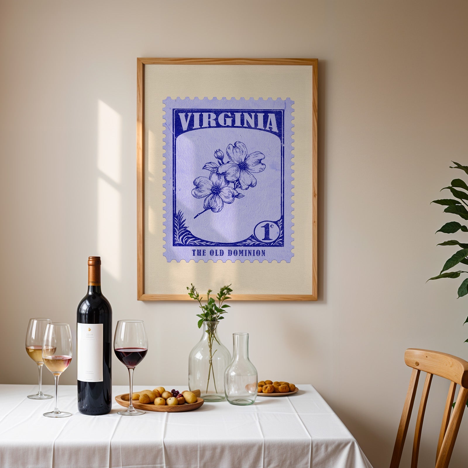 Virginia stamp print framed on the wall above a dining table set with wine, glasses and olives