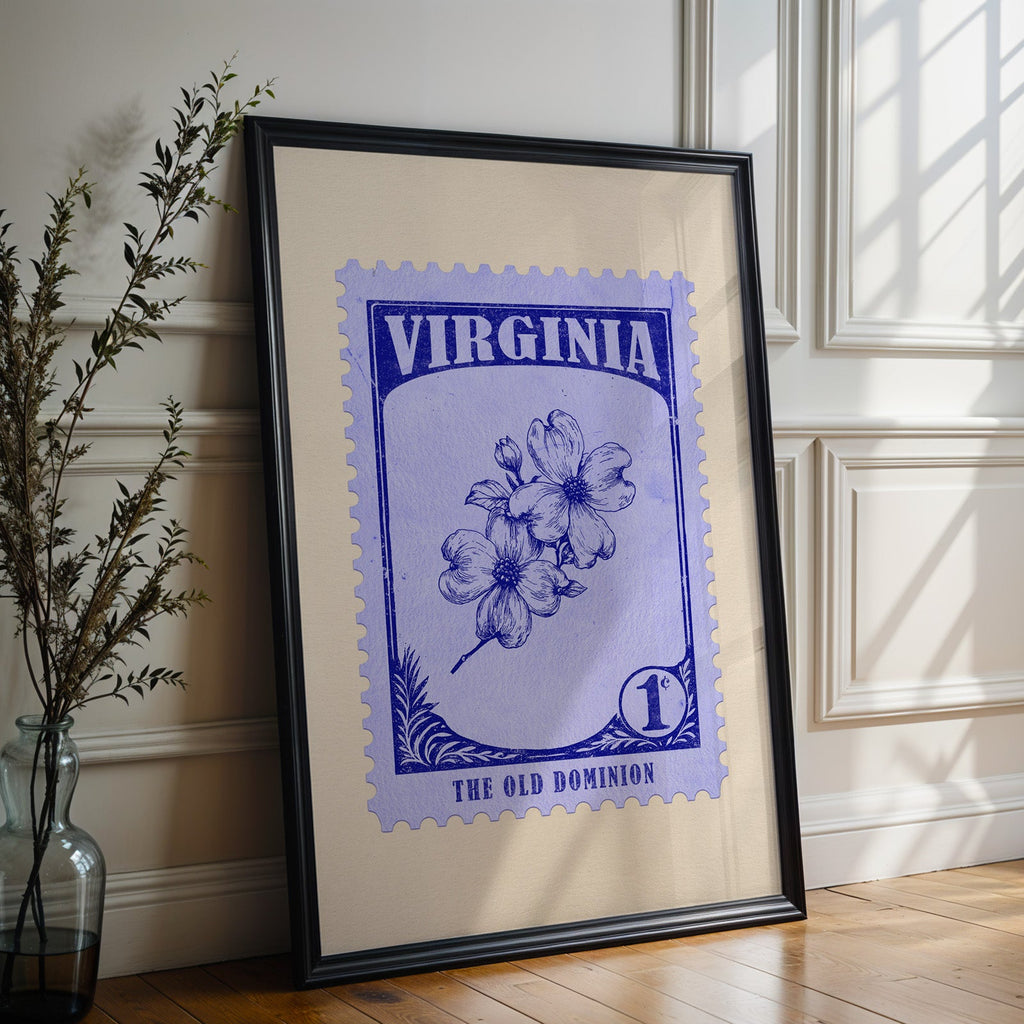 Virginia state flower print in a black frame leaning against a white panelled wall beside olive branches