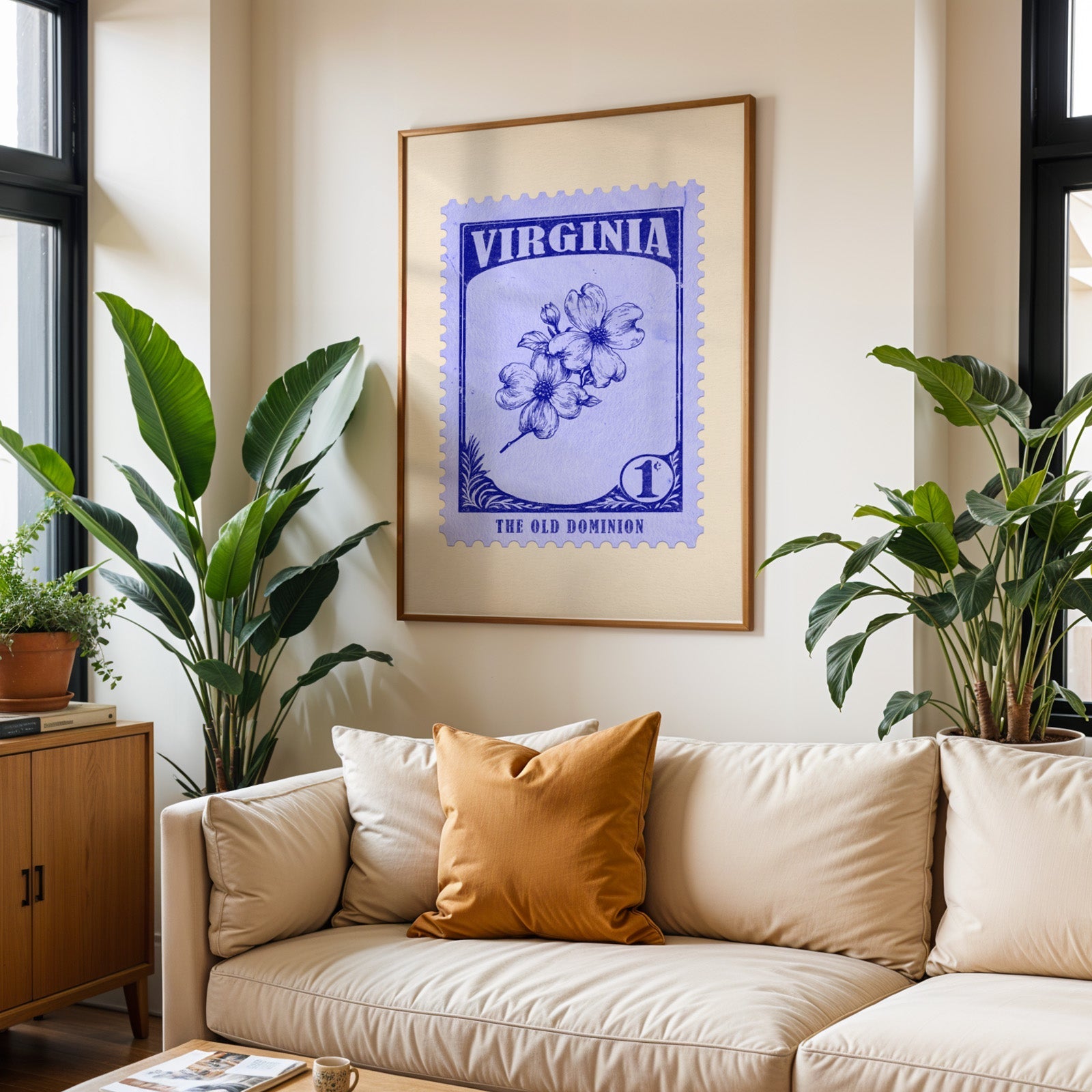 Virginia state flower print framed above a cream sofa with an ochre cushion and large plants either side