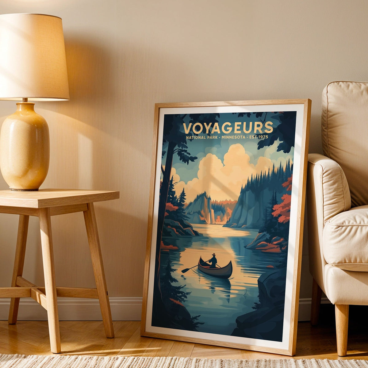 Voyageurs print in an oak frame beside a cream armchair and an amber lamp in warm afternoon light