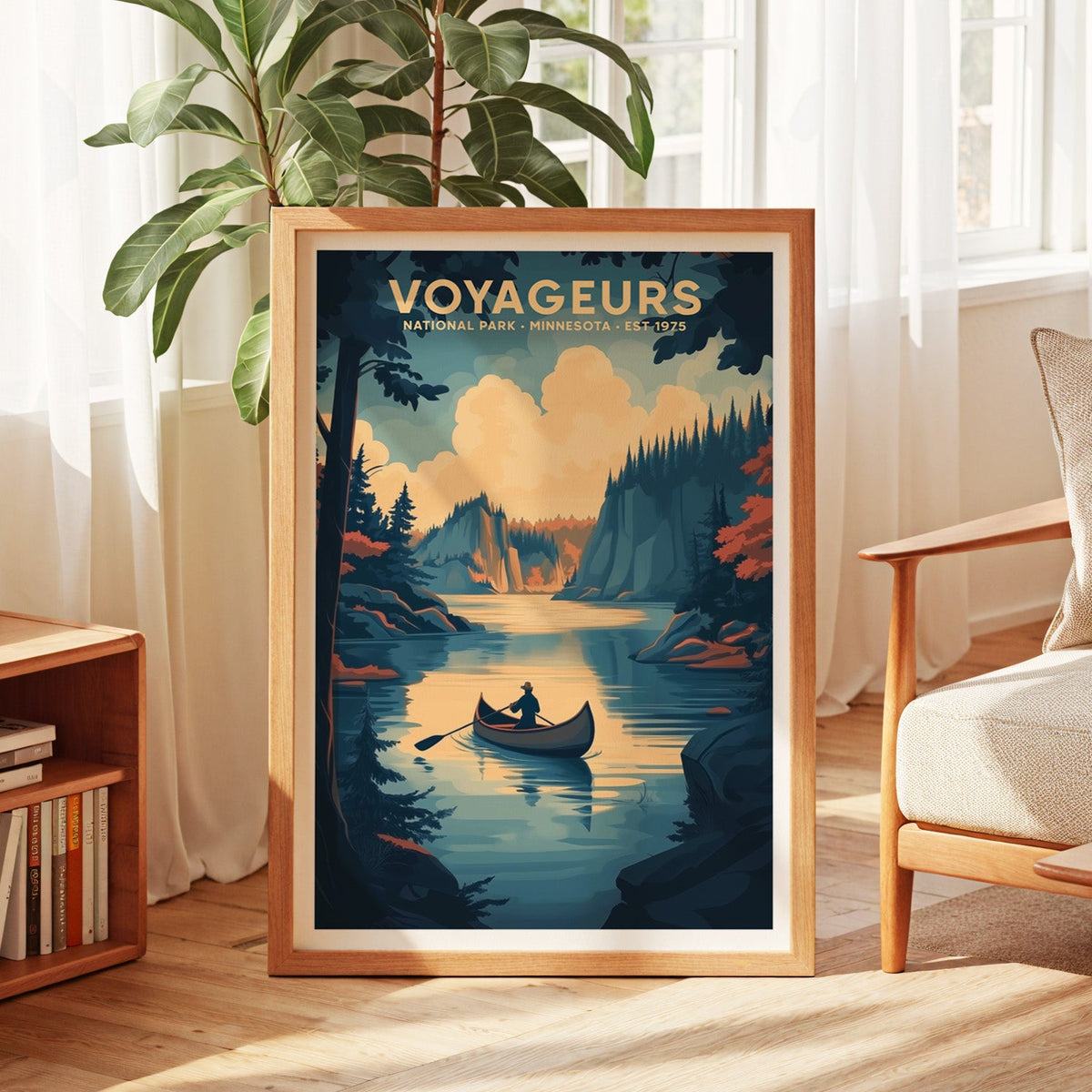 Voyageurs National Park print in an oak frame by a sunlit window with sheer curtains and a fig plant