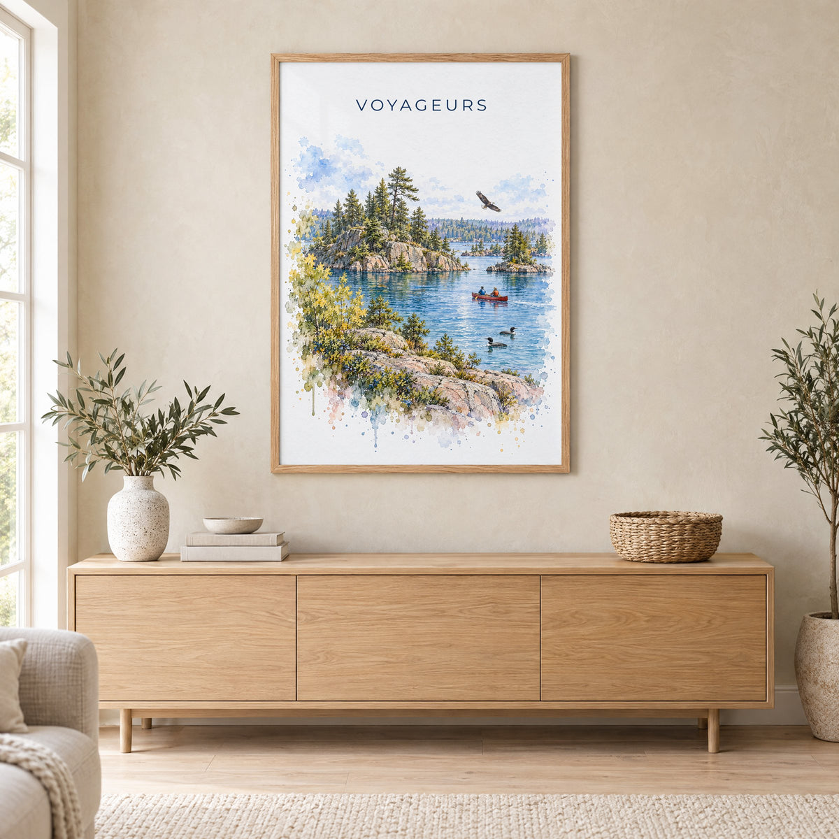 Voyageurs National Park watercolor print in an oak frame above a light wood sideboard in a Scandinavian living room