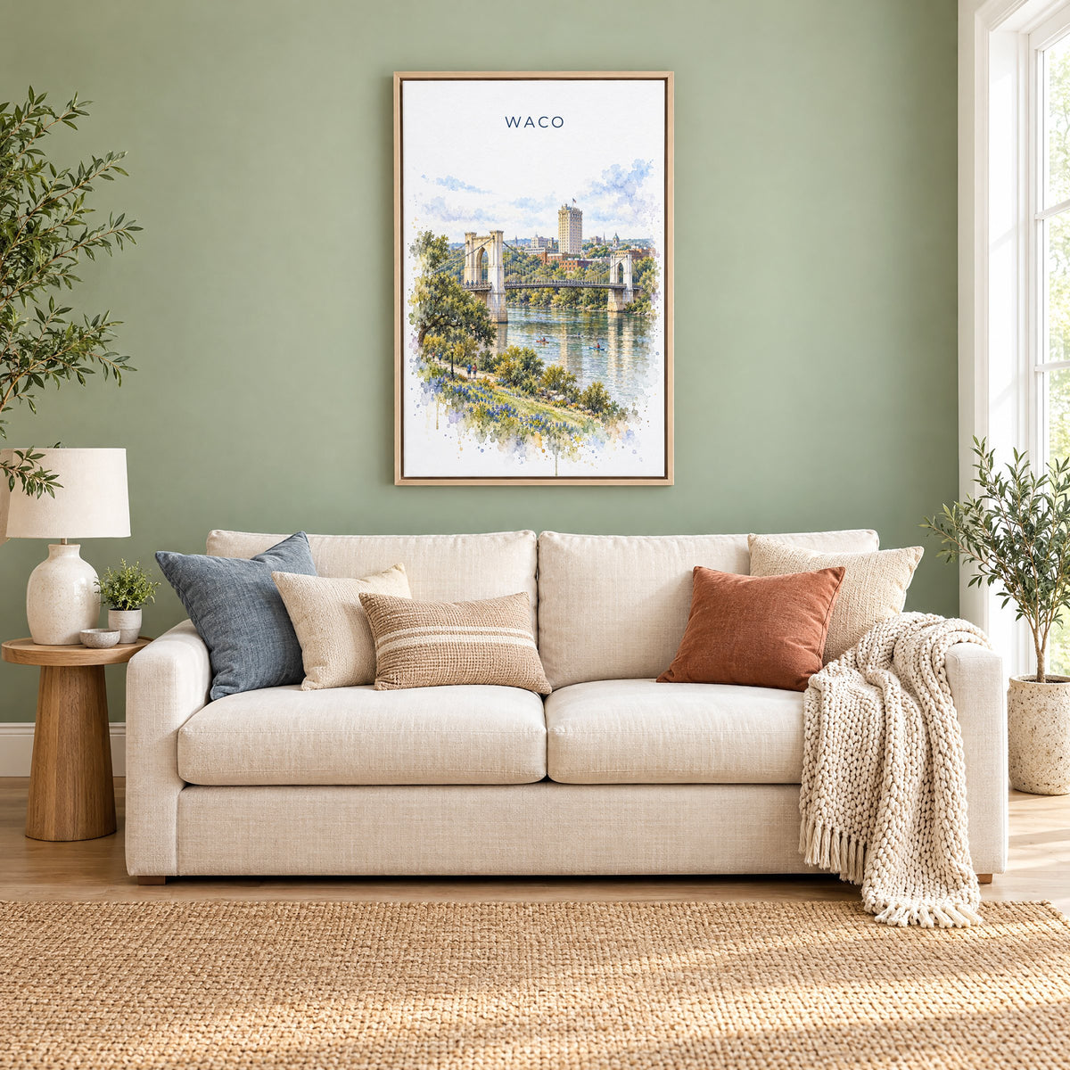 Waco watercolor print as a natural floater canvas above a cream linen sofa on a sage green wall