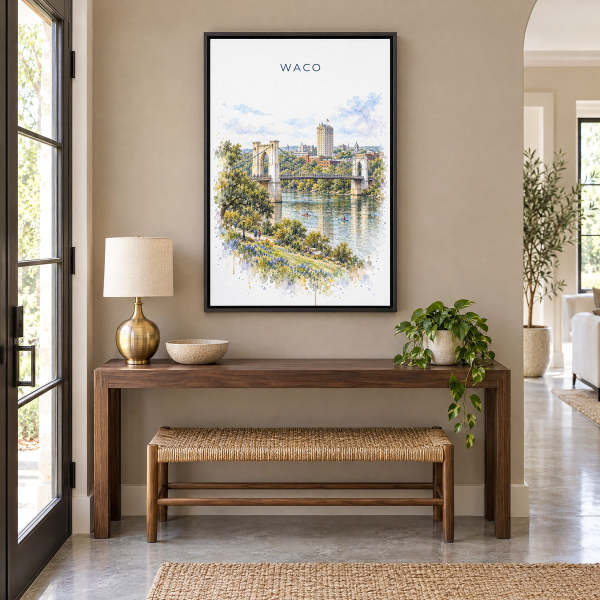 Waco watercolor print as a black floater canvas above a walnut console and woven bench in an entryway