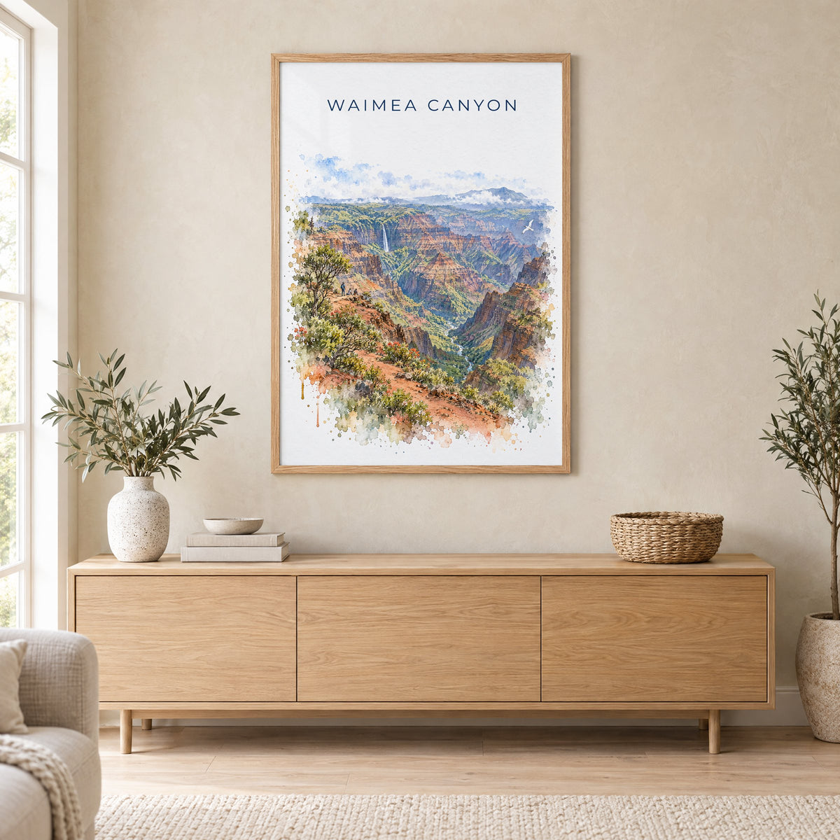 Waimea Canyon watercolor print in an oak frame above a light wood sideboard in a Scandinavian living room