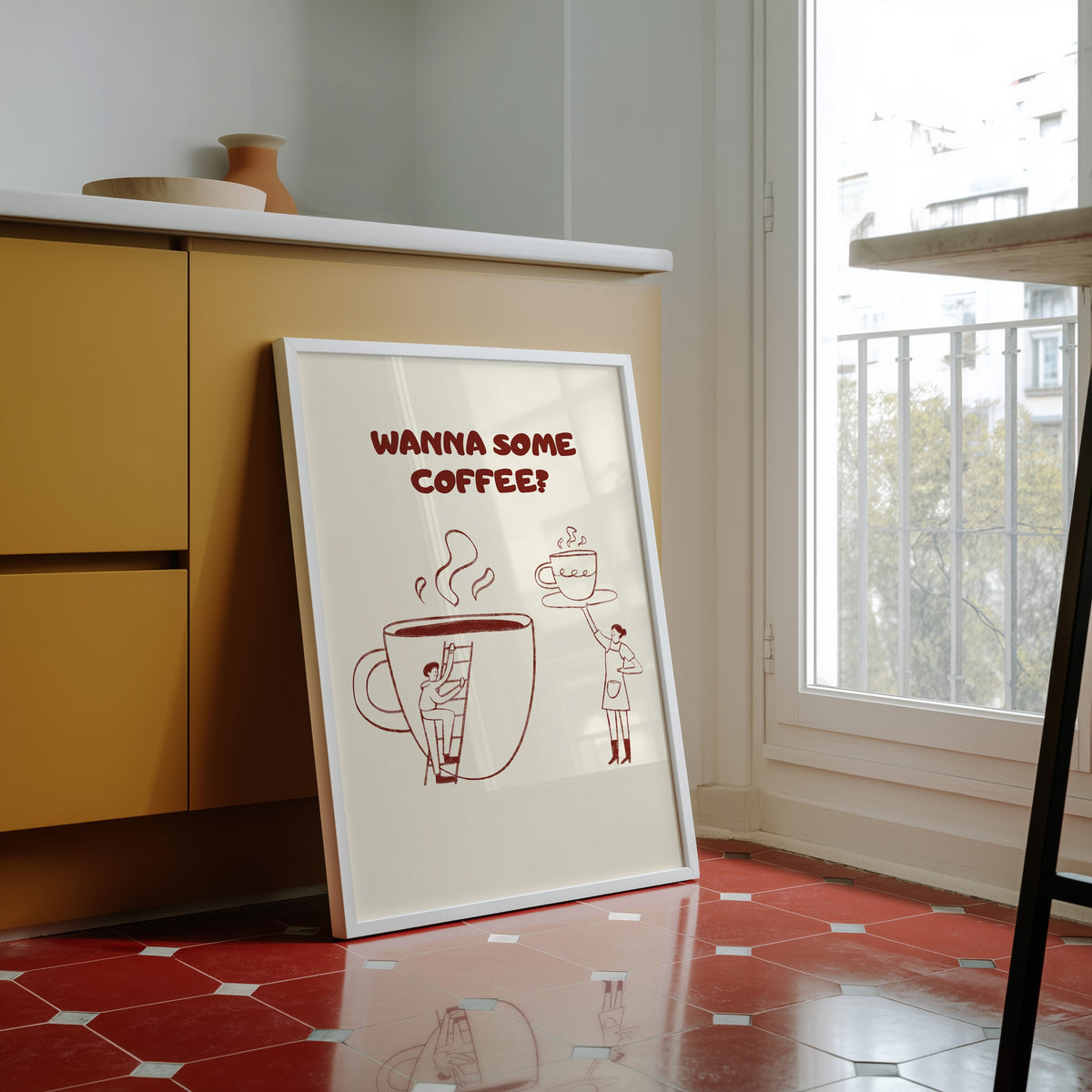 Wanna Some Coffee print in a white frame against yellow cabinets on a red tiled floor