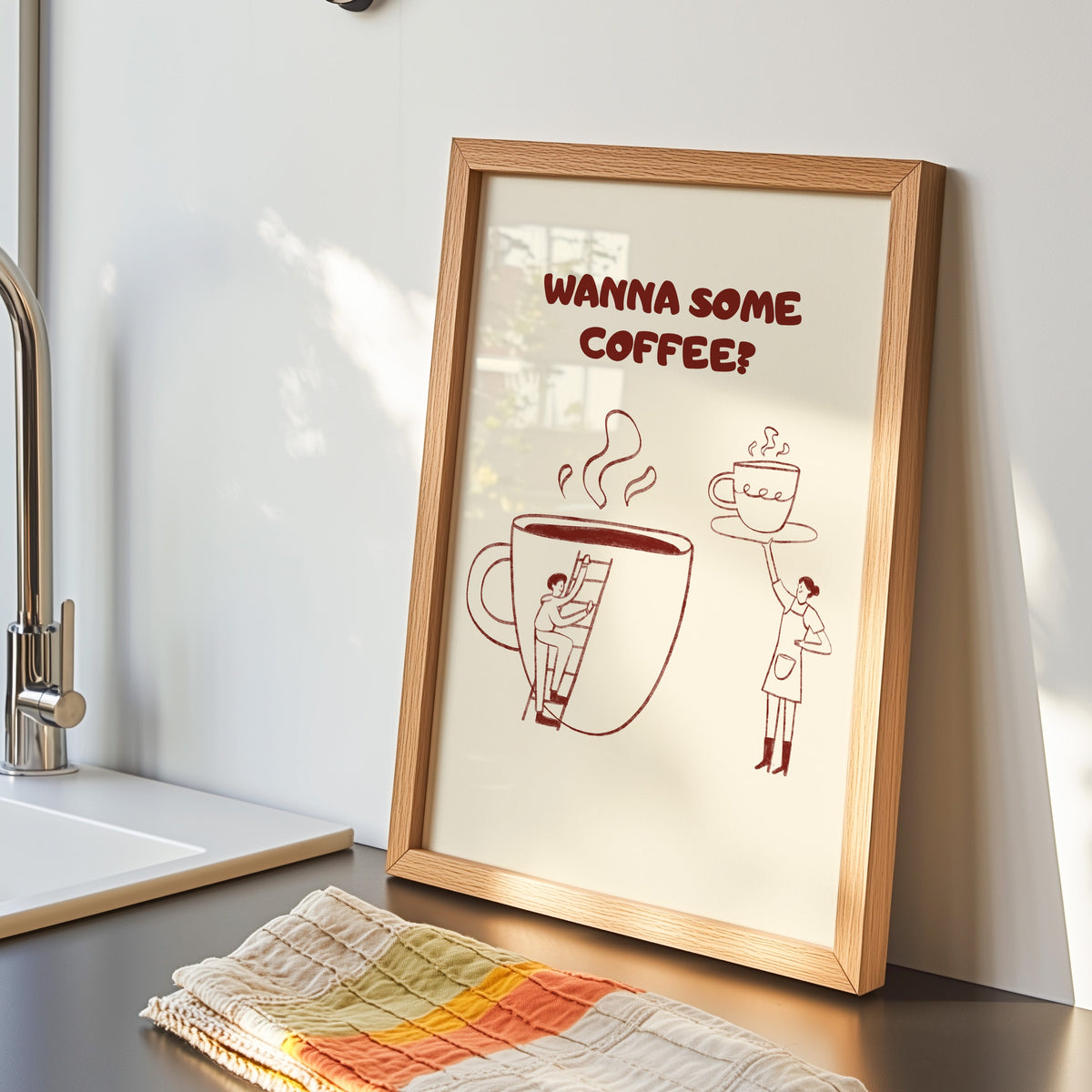 Wanna Some Coffee print in an oak frame by the kitchen sink beside a striped tea towel