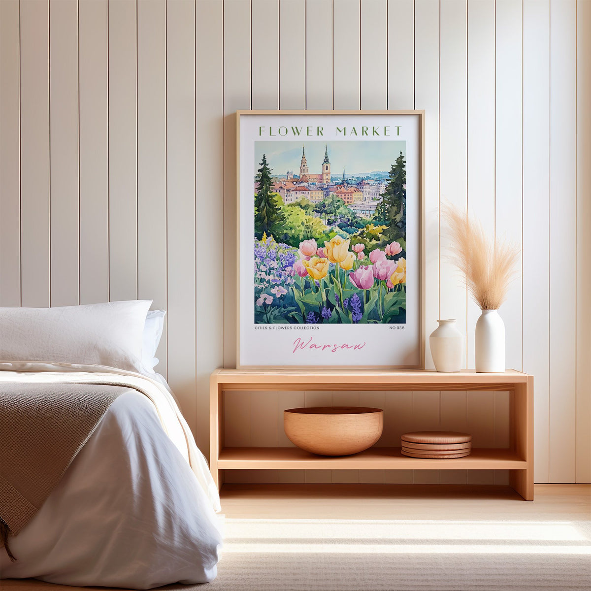Warsaw flower market print in an oak frame on a wood bench against a white shiplap bedroom wall with pampas grass