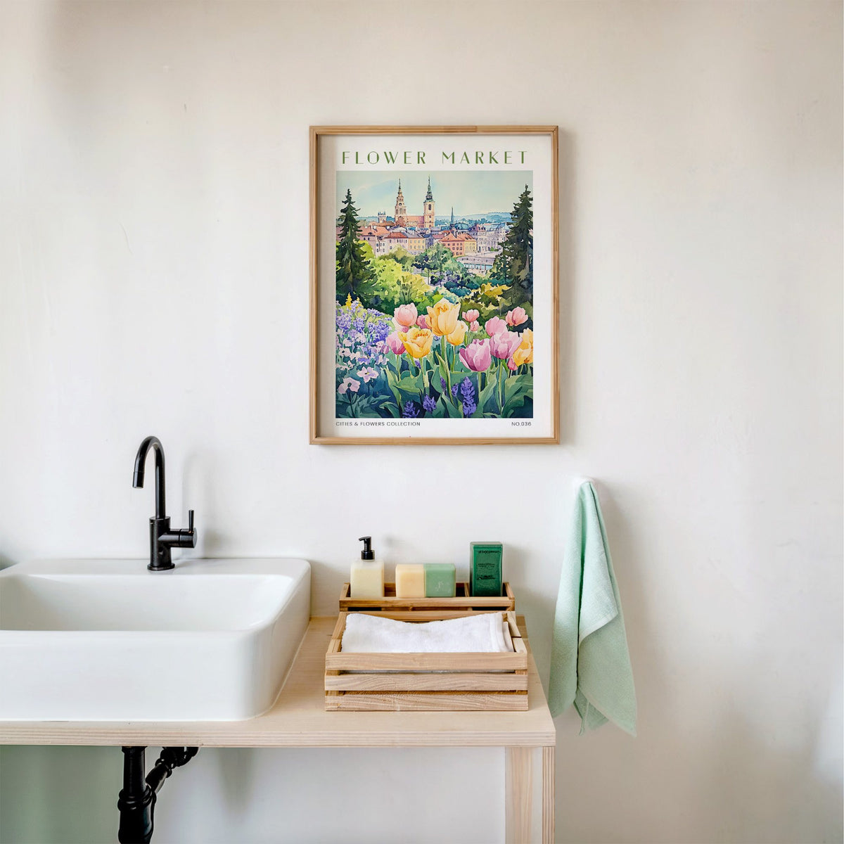 Warsaw flower market print in an oak frame above a white bathroom sink with folded towels