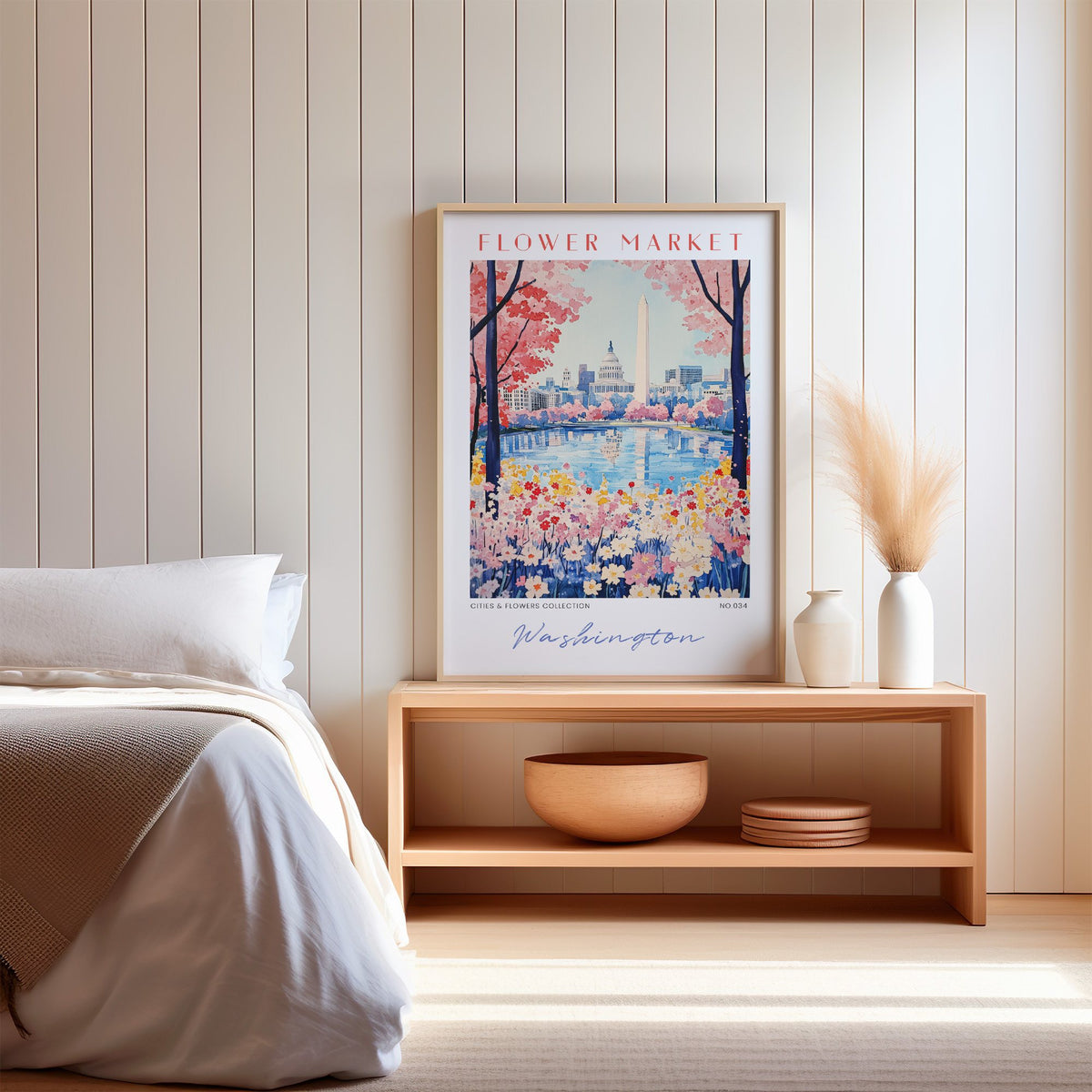 Washington DC flower market print in an oak frame on a wood bench against a white shiplap bedroom wall with pampas grass