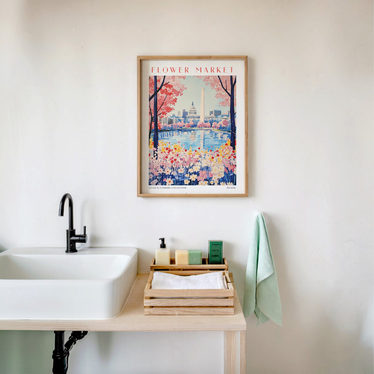 Washington DC flower market print in an oak frame above a white bathroom sink with folded towels