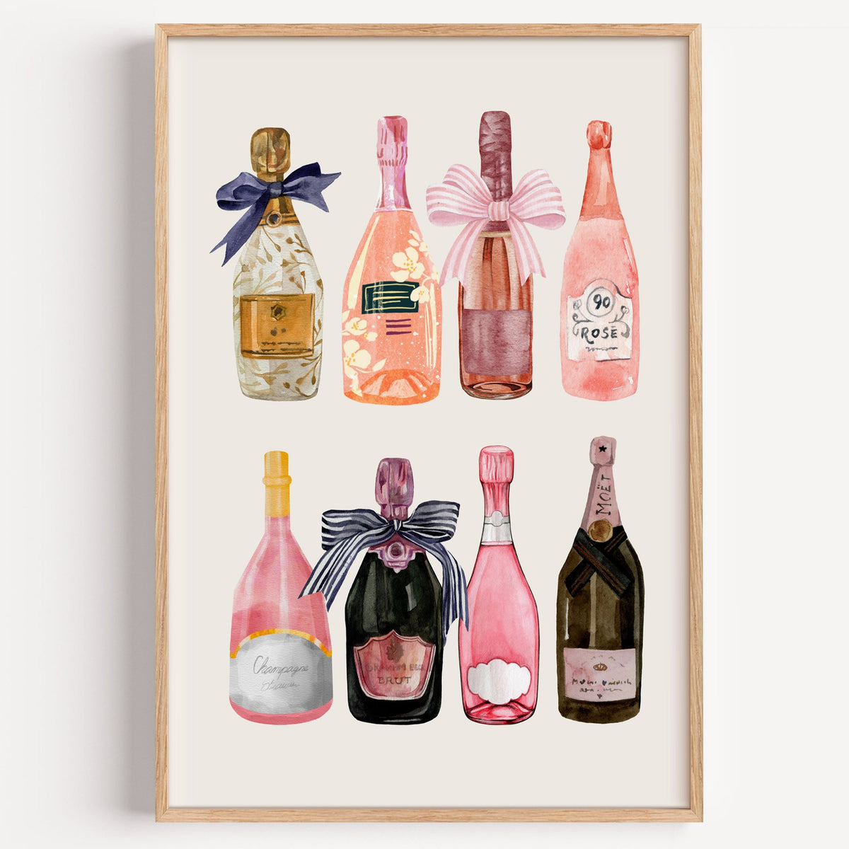 Watercolor champagne bottles print in a light oak frame on a plain white wall