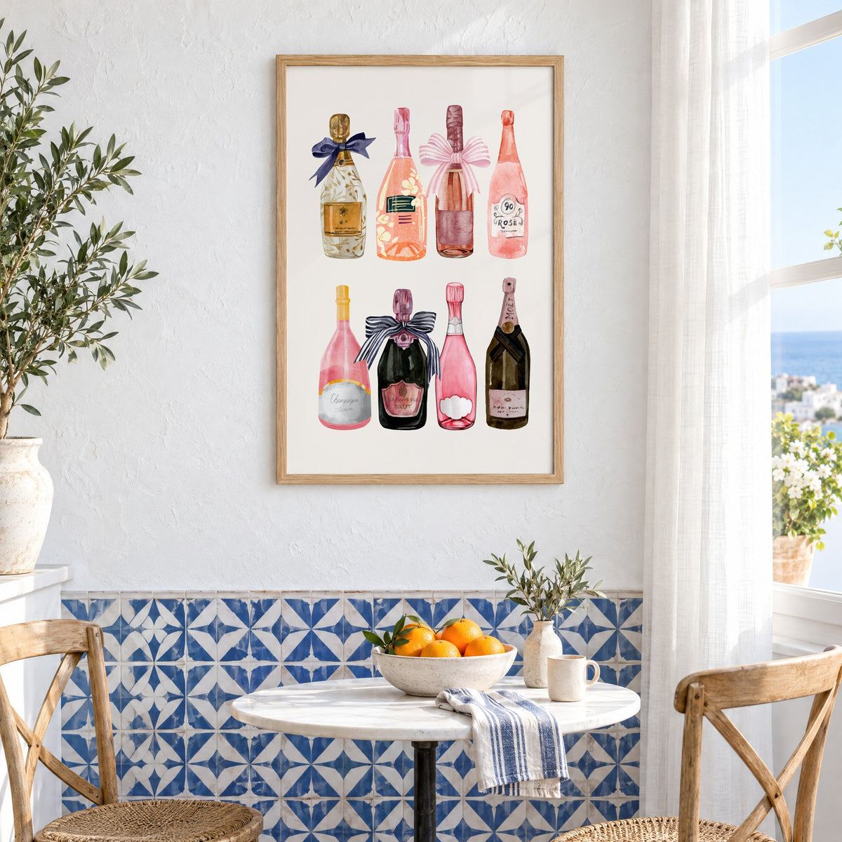 Watercolor champagne bottles print in an oak frame above a bistro table and blue patterned tiles