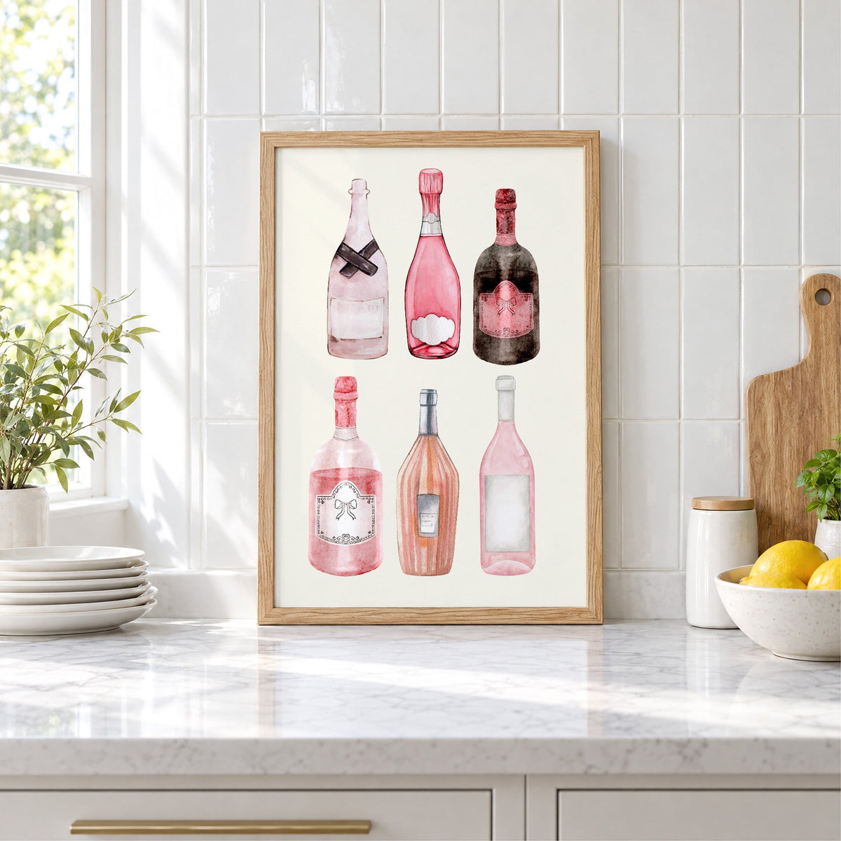Six pink wine bottles watercolor print in an oak frame leaning on a marble counter by white tiles and lemons