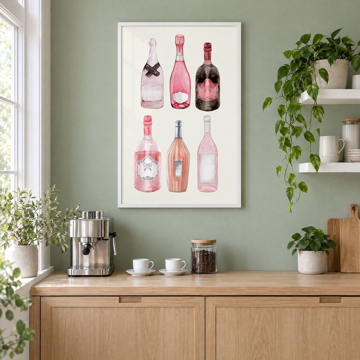 Six pink wine bottles watercolor print in a white frame on a sage green coffee nook wall above an espresso machine