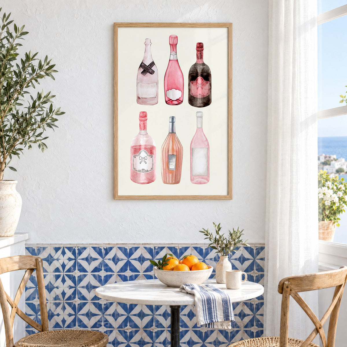 Six pink wine bottles watercolor print in an oak frame above a bistro table and blue patterned tiles
