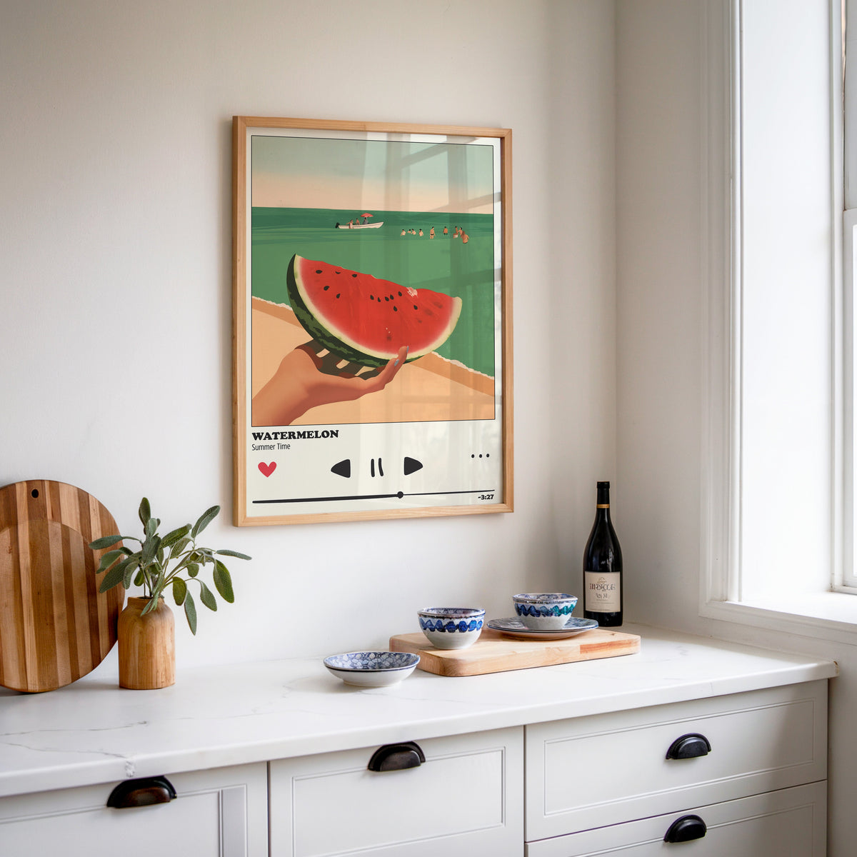 Watermelon Summer print in an oak frame above a white sideboard with a bottle of wine