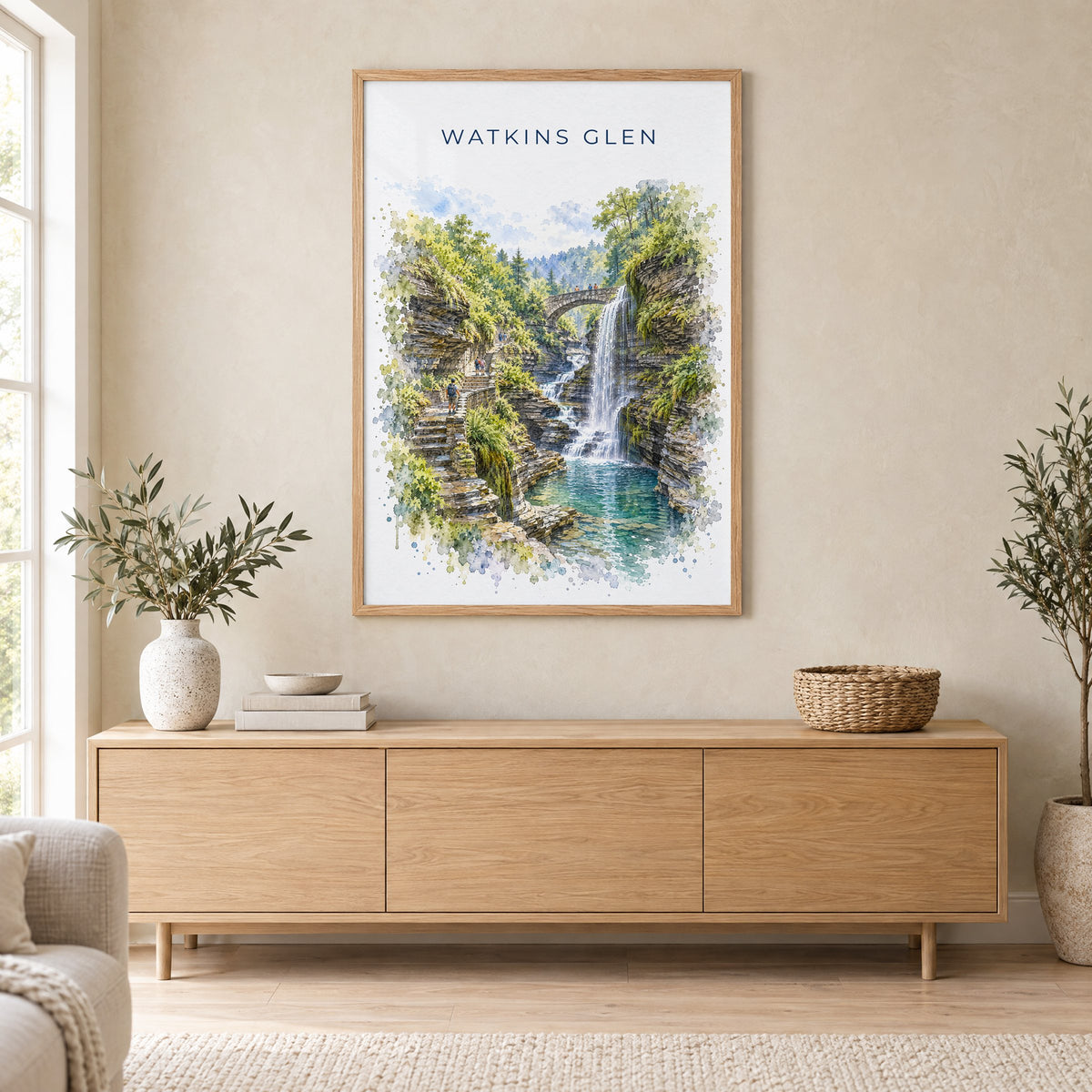 Watkins Glen watercolor print in an oak frame above a light wood sideboard in a Scandinavian living room
