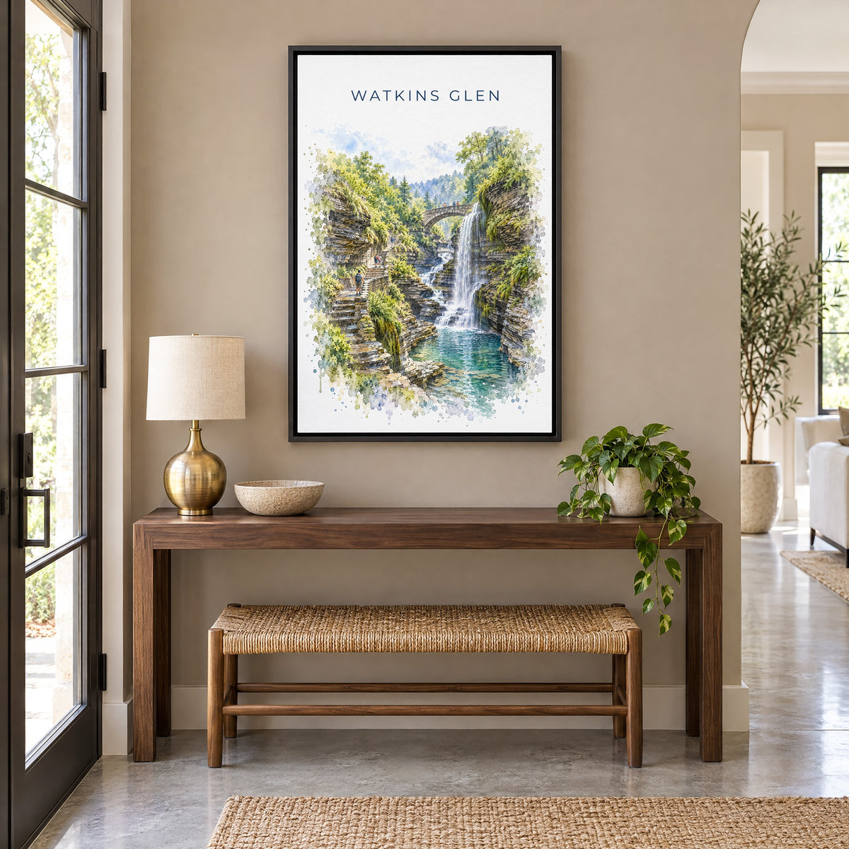 Watkins Glen watercolor print as a black floater canvas above a walnut console and woven bench in an entryway